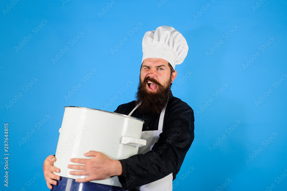 Chef, cook or baker with saucepan in hand. Cooking pot. Chef in uniform cooking with casserole. Professional chef in uniform and hat holds pan.Cooking, food, profession concept - male chef holds pot. Chef, cook or baker with saucepan in hand. Cooking pot. Chef in uniform cooking with casserole. Professional chef in uniform and hat holds pan.Cooking, food, profession concept - male chef holds pot.