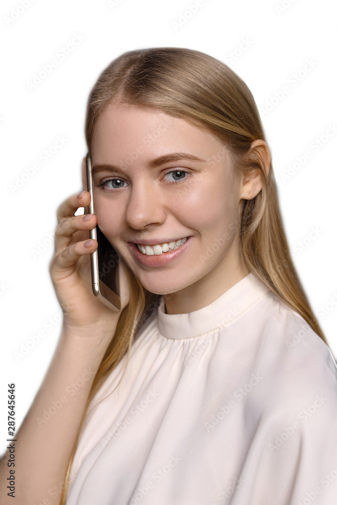 Close up of young pretty blonde girl with long hair, blue eyes smiling and using cell phone isolated on white background Close up of young pretty blonde girl with long hair, blue eyes smiling and using cell phone isolated on white background