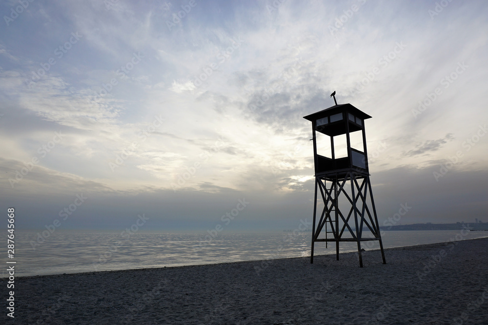 Lifeguard tower on the beach at sunset.