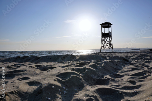 Lifeguard tower on beach at daytime.