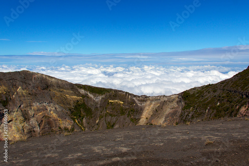 A blanket of clouds, on a clear day, reaches the top of the Irazu volcano in Costa Rica