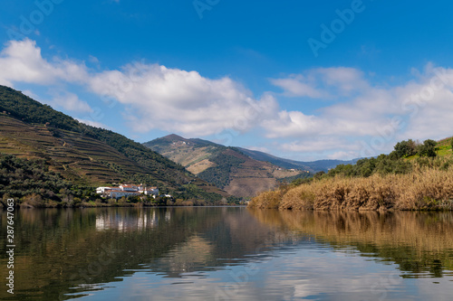 Scenic view of the Pinhao village with terraced vineyards and the Douro River and the Douro Valley, in Portugal; Concept for travel in Portugal and most beautiful places in Portugal