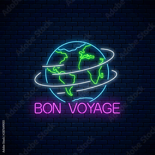 Fototapeta Bon voyage glowing neon banner with spinning earth sign and text