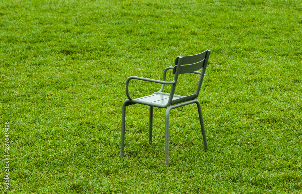 metal street chairs on green grass in the summer during the daytime metal street chairs on green grass in the summer during the daytime