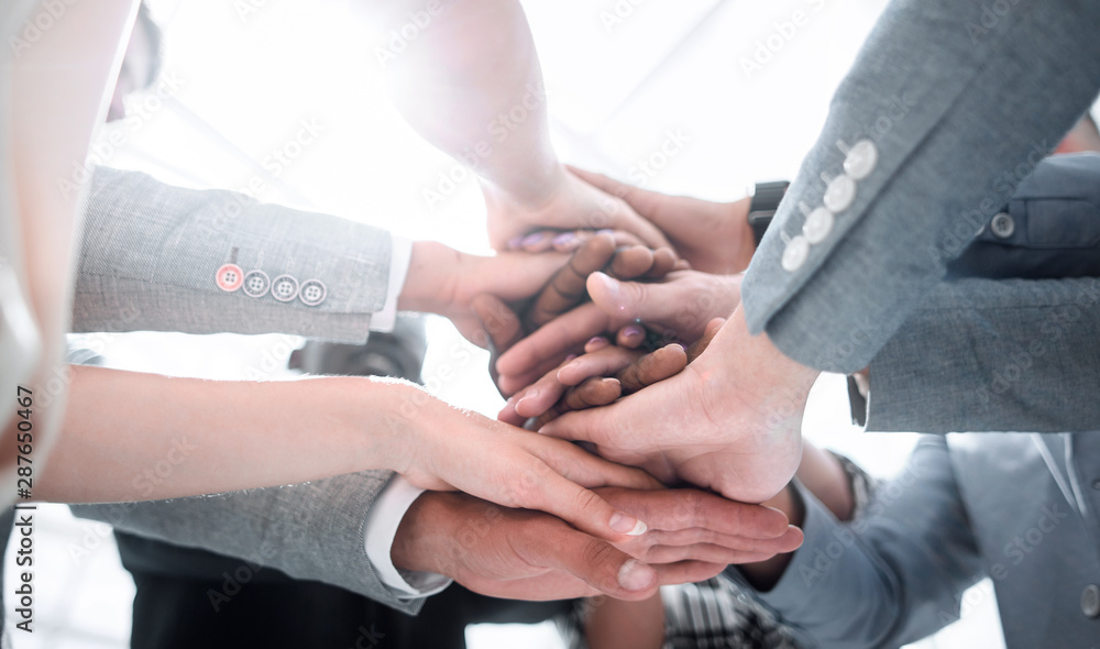 Closeup of a business colleagues with their hands stacked together Closeup of a business colleagues with their hands stacked together