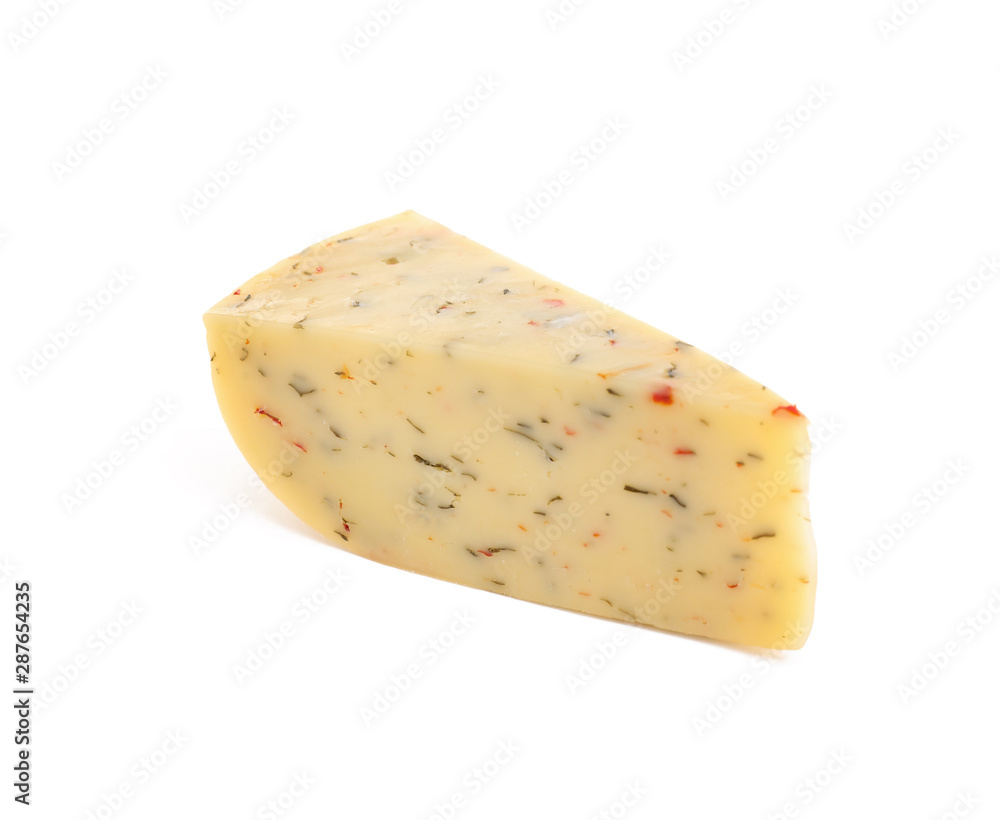 Piece of tasty cheese with basil and paprika isolated on white