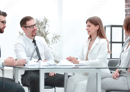 boss and business team sitting at the Desk.