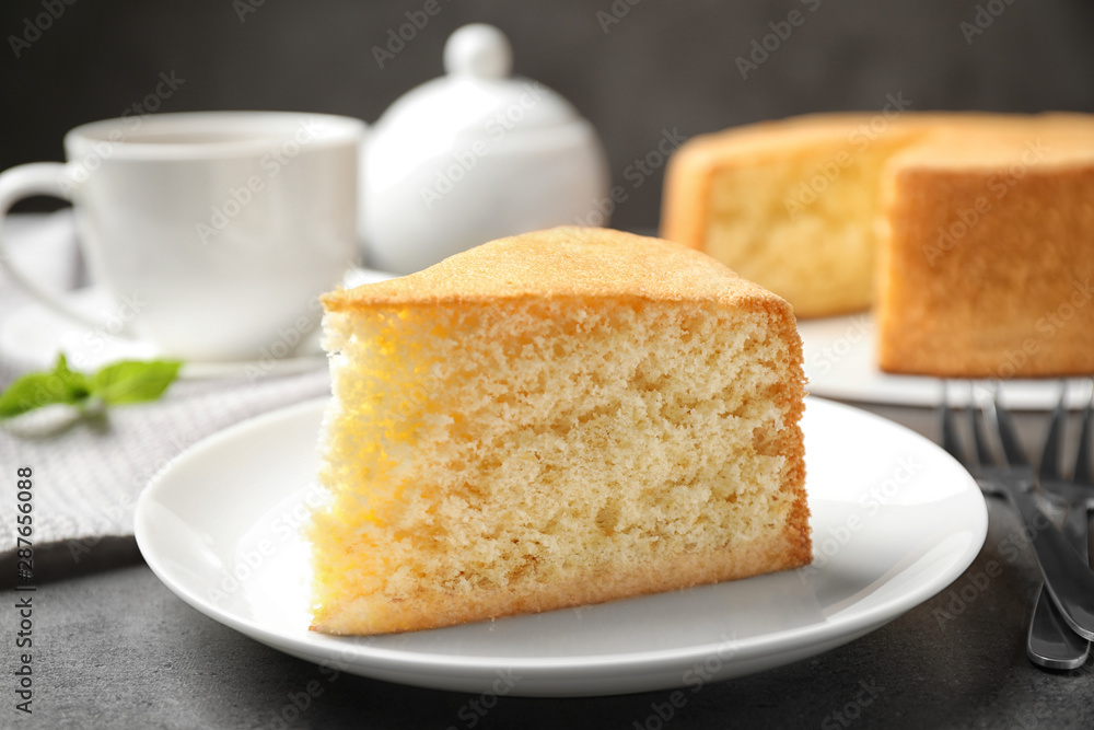 Piece of delicious fresh homemade cake on grey marble table Piece of delicious fresh homemade cake on grey marble table