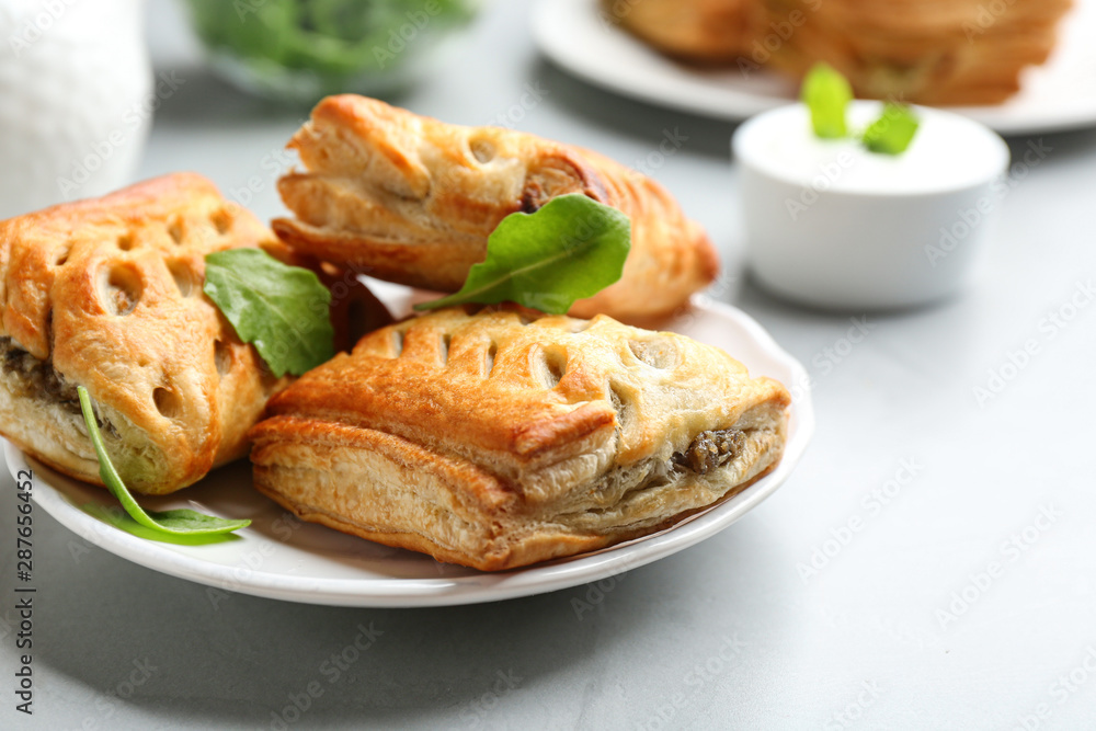 Fresh delicious puff pastry served on light table, closeup