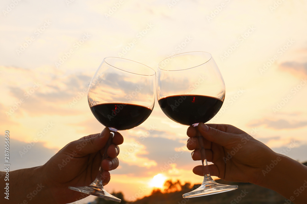 Romantic couple drinking wine together on beach, closeup view