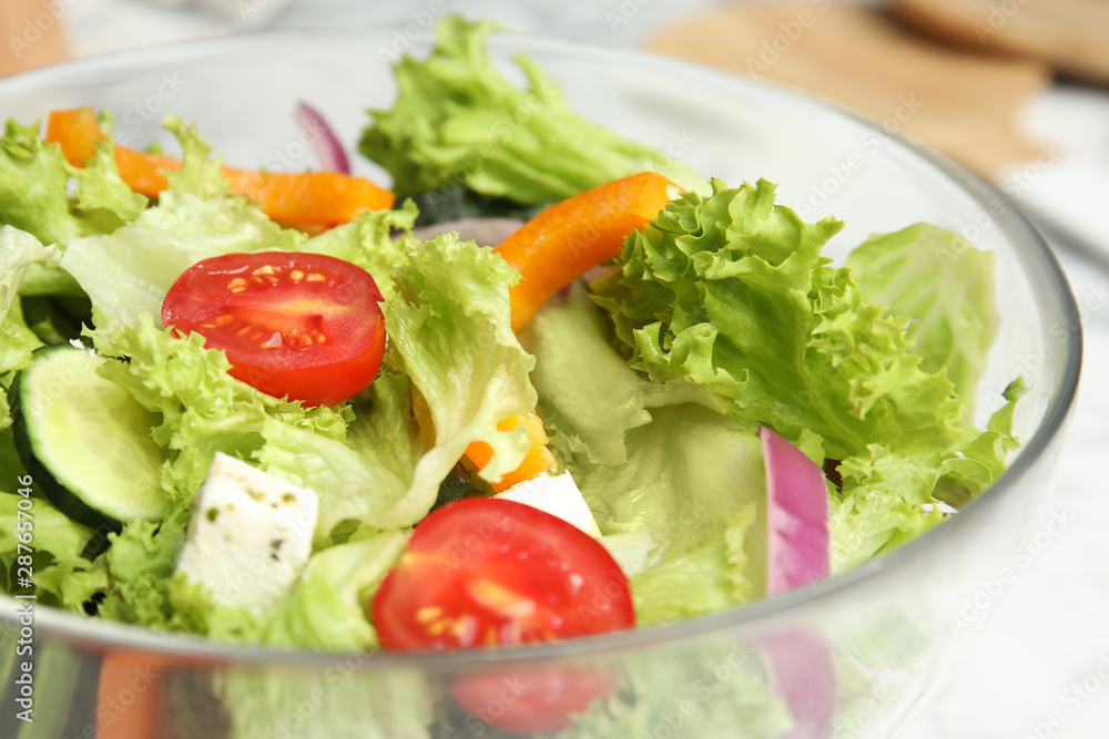 Bowl of tasty fresh Greek salad on table, closeup Bowl of tasty fresh Greek salad on table, closeup