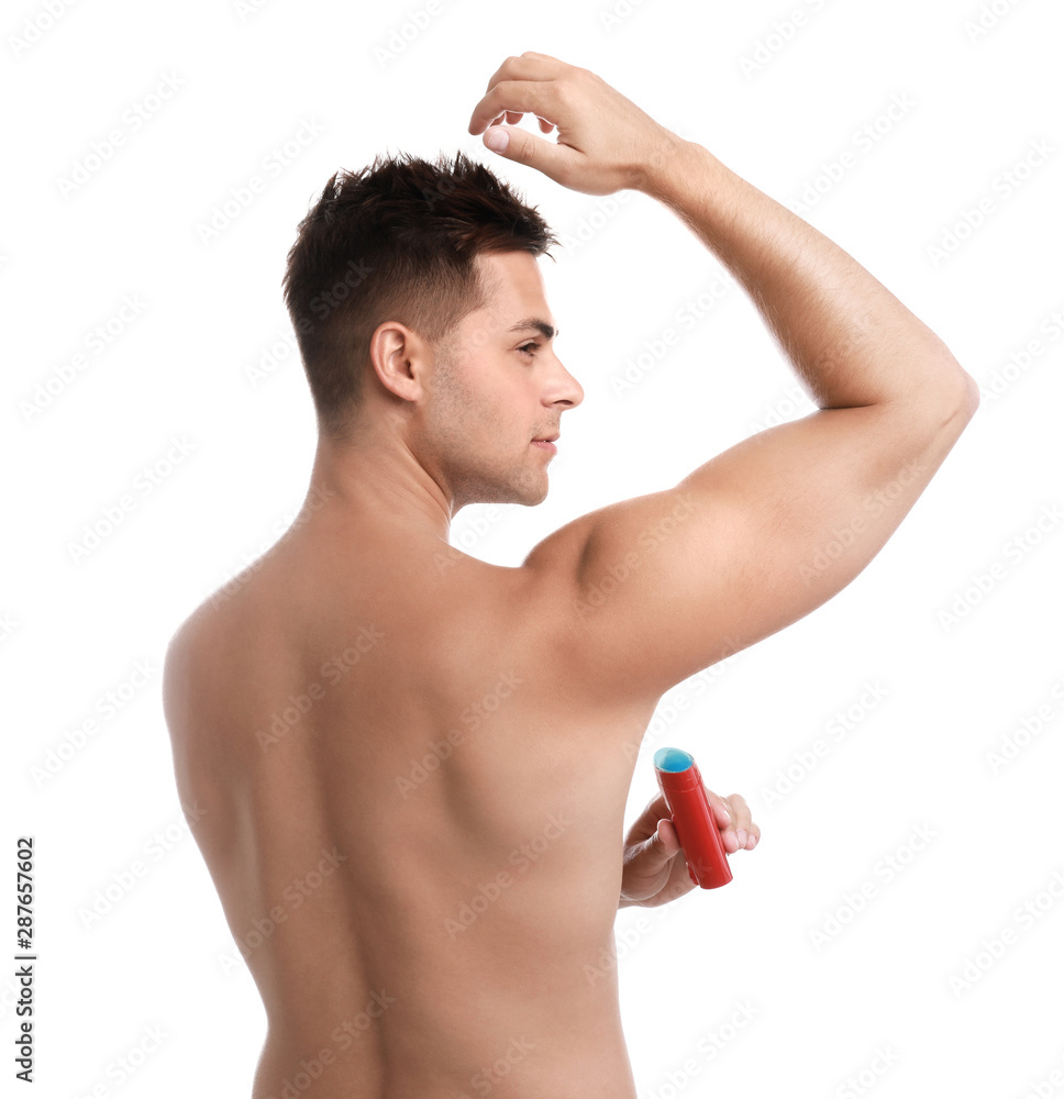 Young man applying deodorant to armpit on white background Young man applying deodorant to armpit on white background