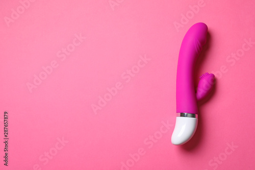 Dildo on pink background, top view with space for text. Sex toy © New Africa