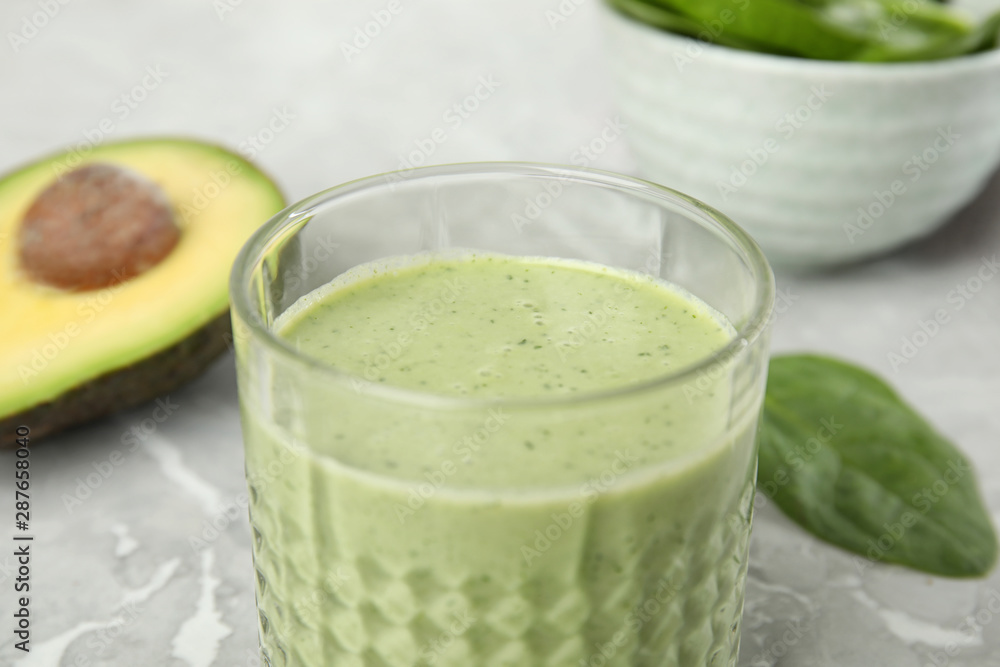 Glass of tasty avocado smoothie on table, closeup Glass of tasty avocado smoothie on table, closeup
