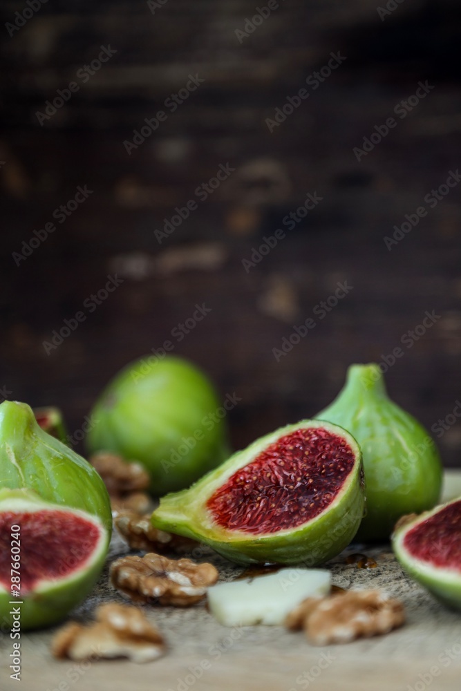 fresh figs, nuts and cheese on wooden table fresh figs, nuts and cheese on wooden table