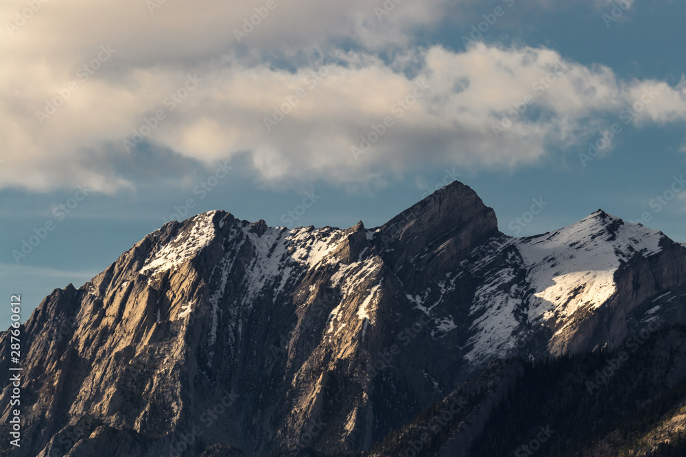 Beautiful mountain peaks during golden hour of sunset still with snow along them