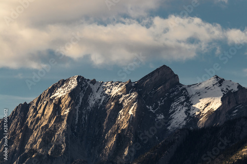 Beautiful mountain peaks during golden hour of sunset still with snow along them