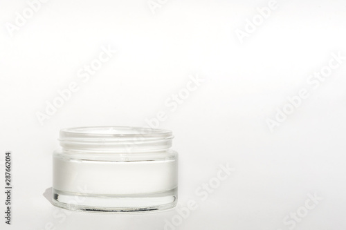 White facial cream jar. Cosmetic moisturizing product. Skin and body care, moisture lotion, wellness therapy mask in glass jar