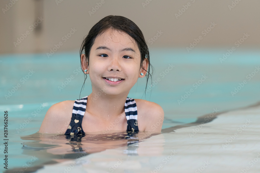 Portrait of Asian teen girl posing in swimming pool Stock Photo | Adobe ...