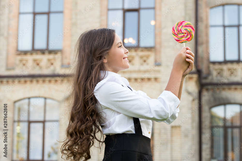 Happy kid with sweet candy. Happy childhood. Kid child holding lollipop
