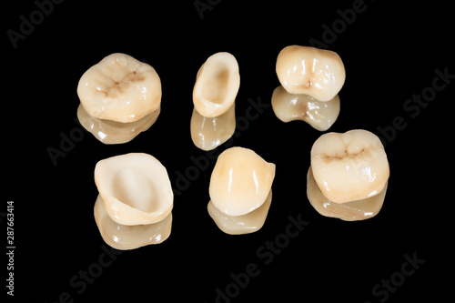 Canvas Print ceramic crowns of human teeth closeup macro isolate on a black background