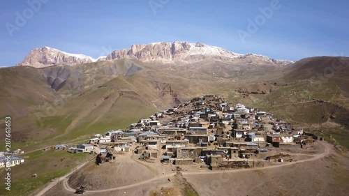 Aerial View Of Old Village With Snow Covered Mountain In The Background