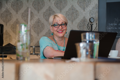 Wallpaper Mural Beautiful mature woman working on laptop Torontodigital.ca