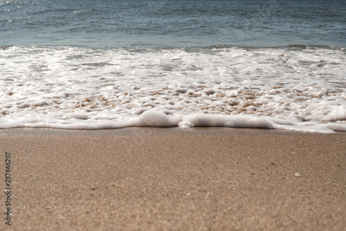 Close-up of Foamy Water Rolling into Shore photo