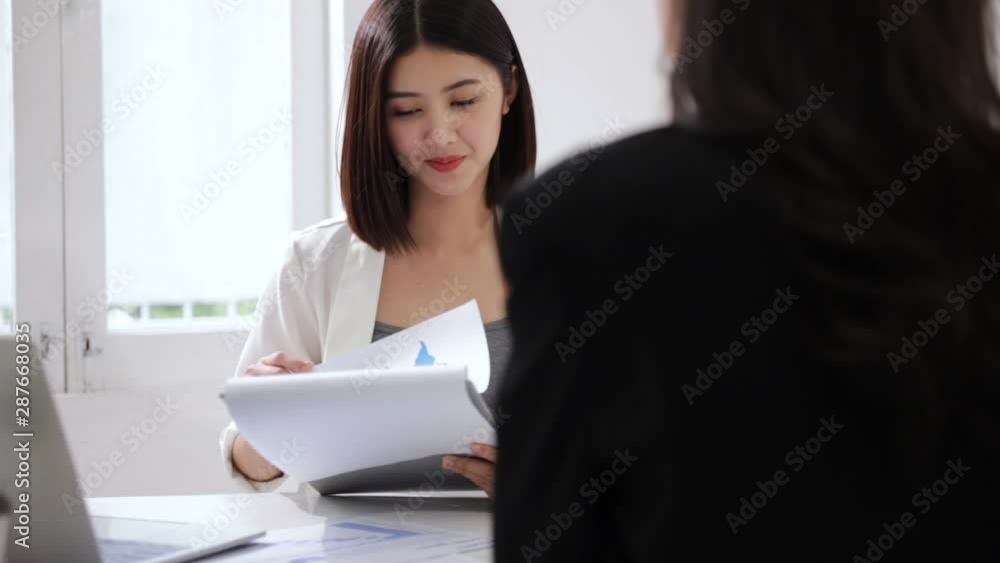 A young attractive asian woman is interviewing for a job. Her interviewers are diverse. Human resources manager conducting job interview with applicants in office A young attractive asian woman is interviewing for a job. Her interviewers are diverse. Human resources manager conducting job interview with applicants in office