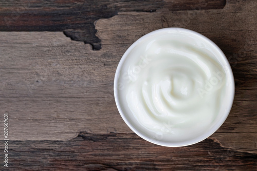 Yogurt  in white glass on wood background from top view.