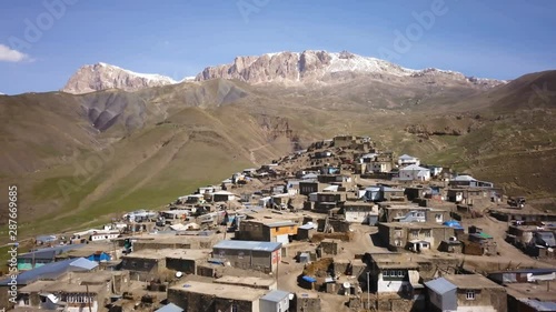Drone Reveal Of A Mountain Top Village On A Sunny Day