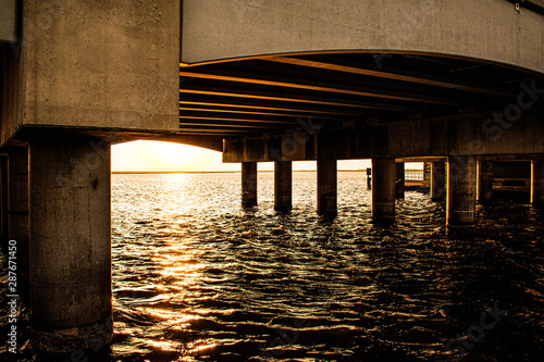 Fishing pier at sunrise underbridge  photo