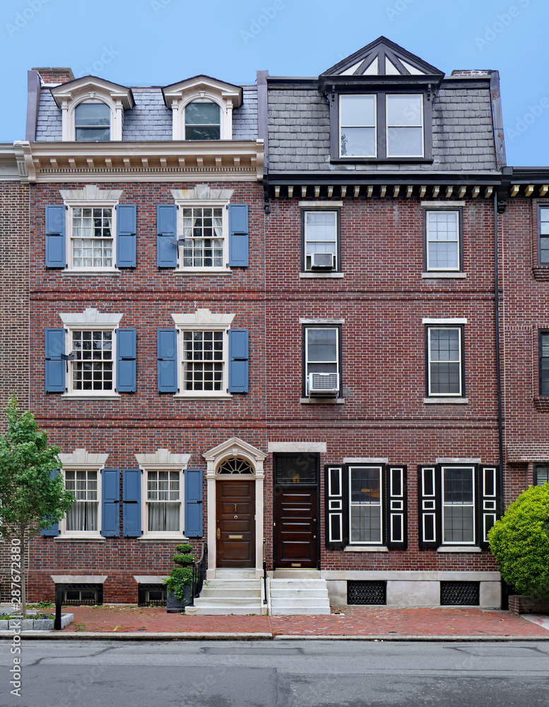 old fashioned tall, narrow brick fronted townhouses
