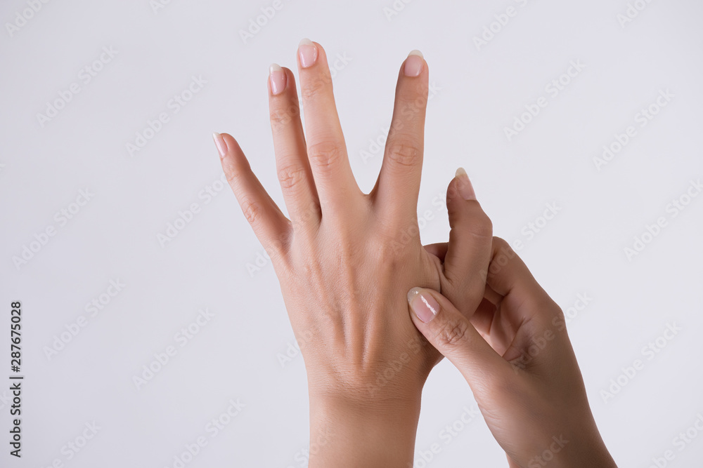 Healthcare and medical concept. Woman massaging her painful hand. Healthcare and medical concept. Woman massaging her painful hand.