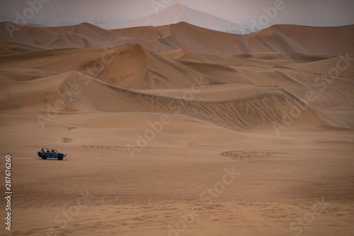 Huacachina a world with buggy desert oasis and dunes of Peru