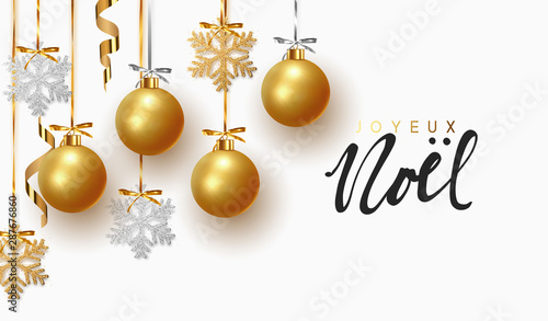 French text Joyeux Noel. Christmas greeting card, design of xmas balls with golden glitter snowflake hanging on the ribbon.