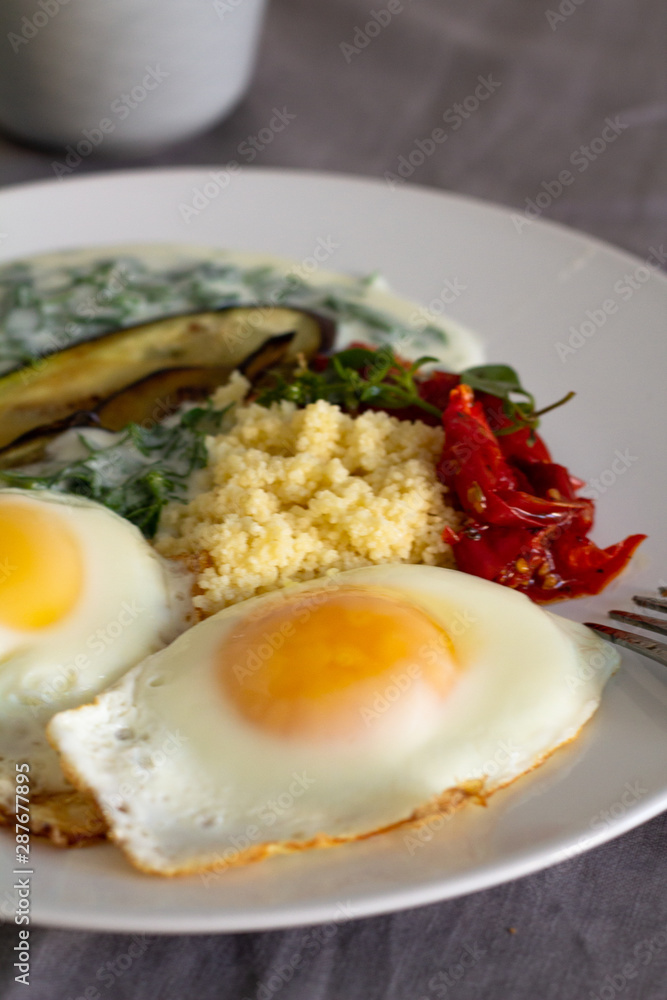 breakfast of fried eggs vegetables and couscous breakfast of fried eggs vegetables and couscous