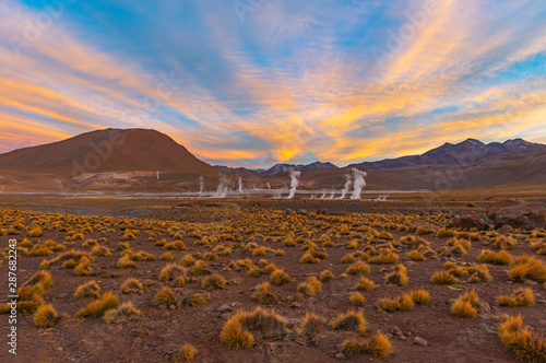 Sunrise in the Andes mountain range of Chile with the steaming water vapor of the Geysers in El Tatio Geyser Field (highest in the world), Atacama Desert, Chile, South America.