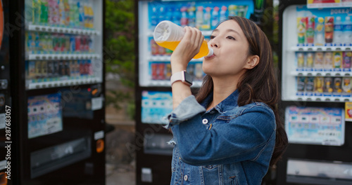 Woman bought a bottle of juice on vending machine