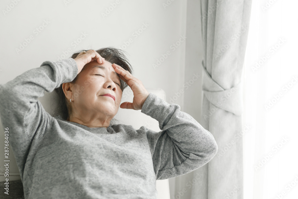 Asian senior woman having headache at home, health care concept. Asian senior woman having headache at home, health care concept.