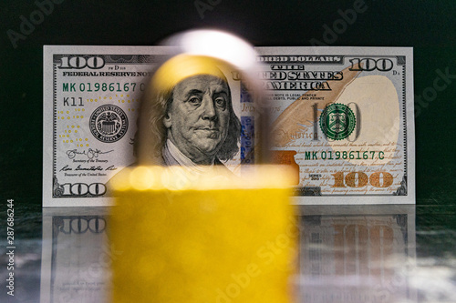 american dollars behind a local on a black background