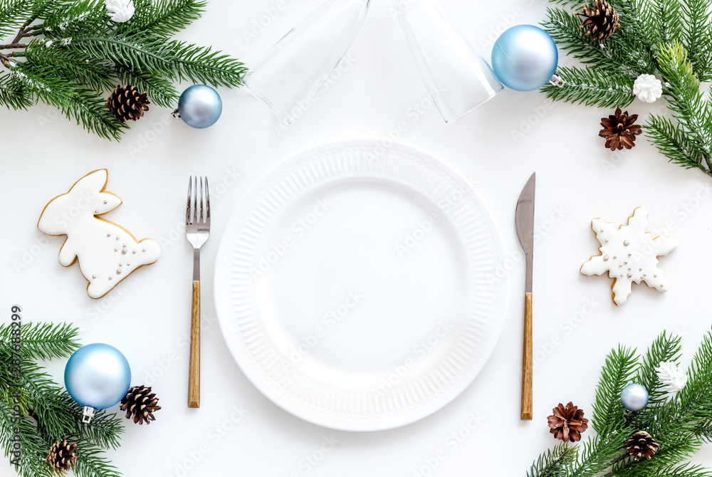 Christmas table setting with fir tree and toys on white background top view Christmas table setting with fir tree and toys on white background top view