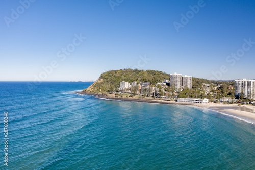  Burleigh heads on the gold coast with nice afternoon sun, gentle waves and beach lifestyle. Aerial view of a favourite holiday destination in Queensland, Australia