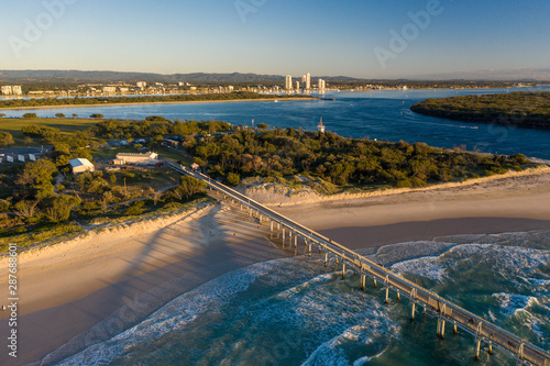 Aerial sunrise view of surfers at the spit on the Gold Coast with nice waves, white sand and beautiful beaches. Summer water with nice colors.