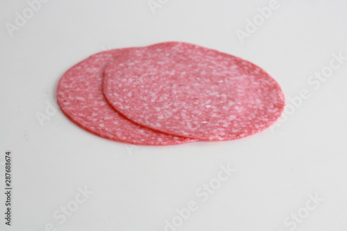 slices of salami on white background