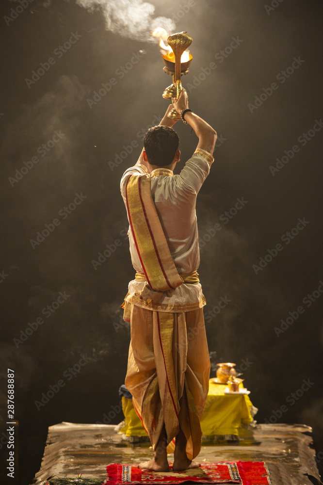 Ganga aarti performed in the evening by an unidentified priest at the Dashashwamedh Ghat. Ganga Aarti is performed at the three holy cities of Haridwar, Rishikesh, and Varanasi, India.