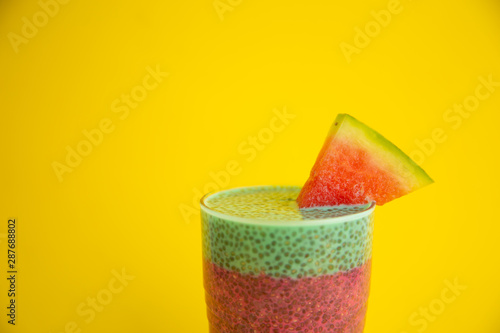 Glass of black chia pudding with watermelon taste