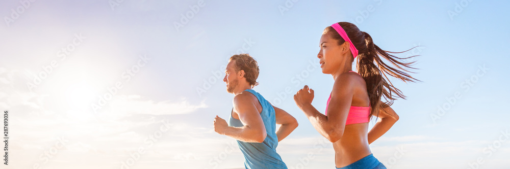 Foto Stock Fitness runners couple doing running exercise run at beach  sunset banner panorama. Healthy sports lifestyle panoramic horizontal crop.  | Adobe Stock