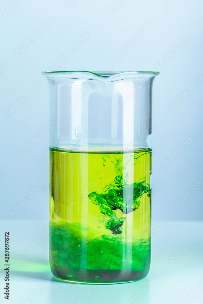 Laboratory flask glassware with reflections on table close up Laboratory flask glassware with reflections on table close up