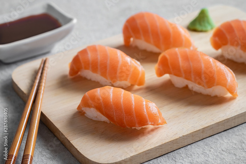 Salmon nigiri sushi on wooden plate, Japanese food